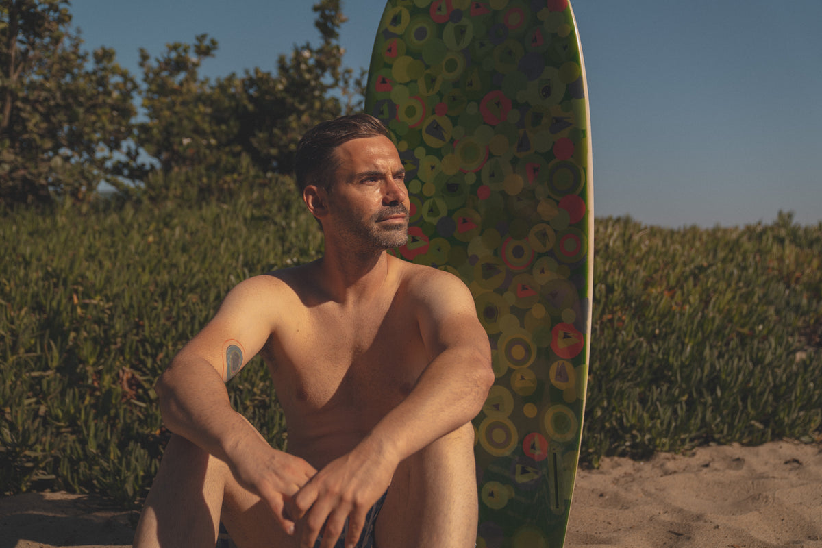 Ivo Spirov with his painted surfboard on the California coast